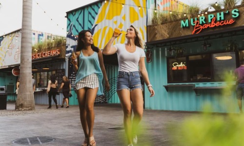 two women walking in the rain